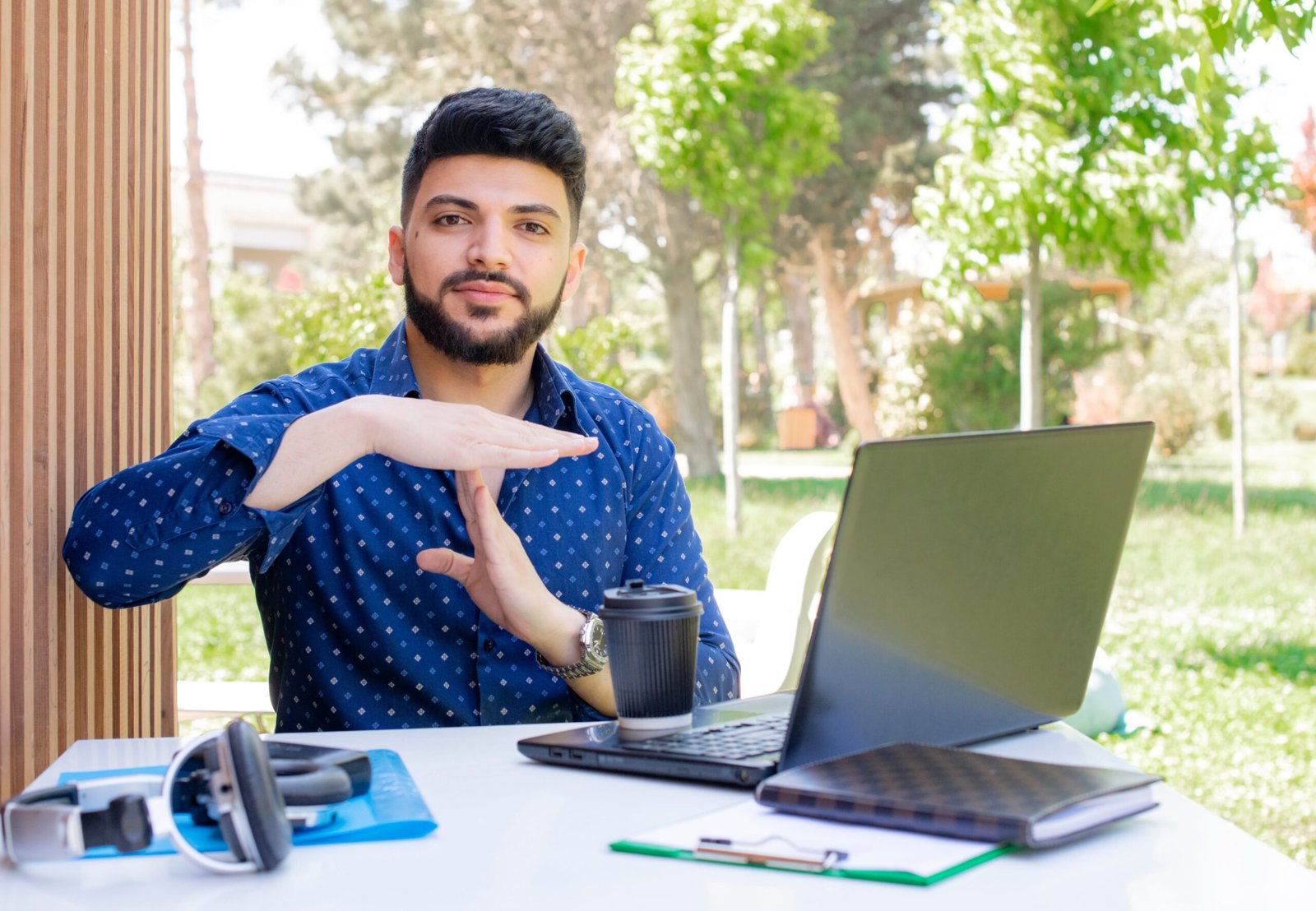 brunette-asian-boy-with-beard-sitting-working-showing-stop(1)